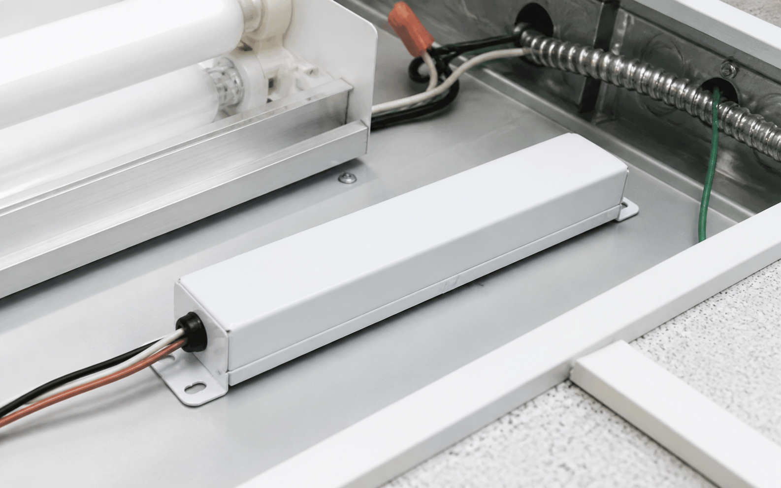 Fluorescent emergency ballast shown in commercial fixture service area