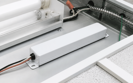 Fluorescent emergency ballast shown in commercial fixture service area