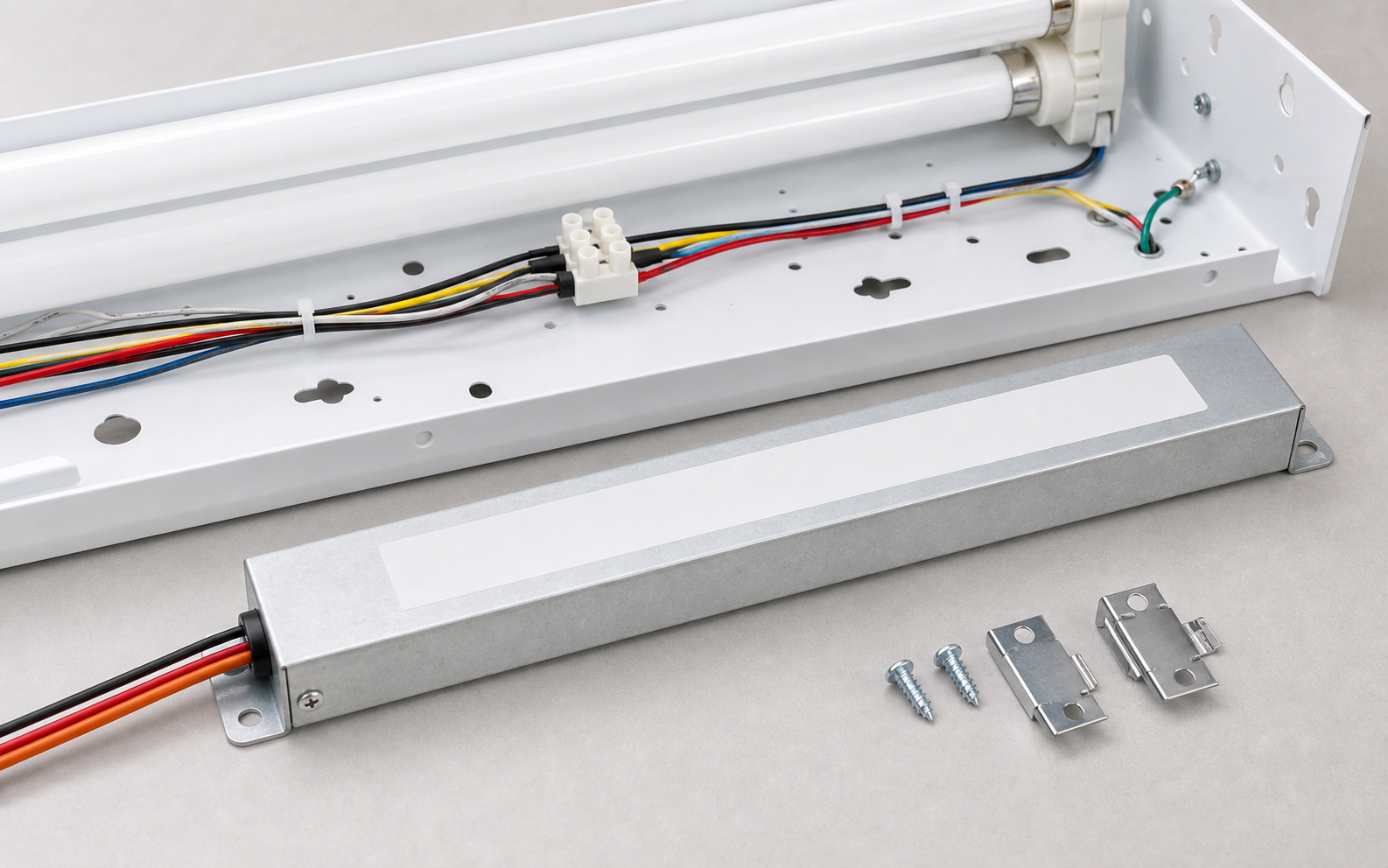 Low-profile emergency ballast staged with slim fluorescent fixture